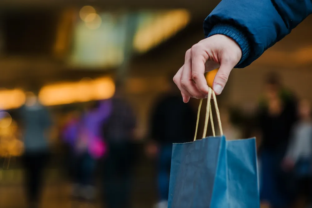 mans-hand-holding-shopping-bag
